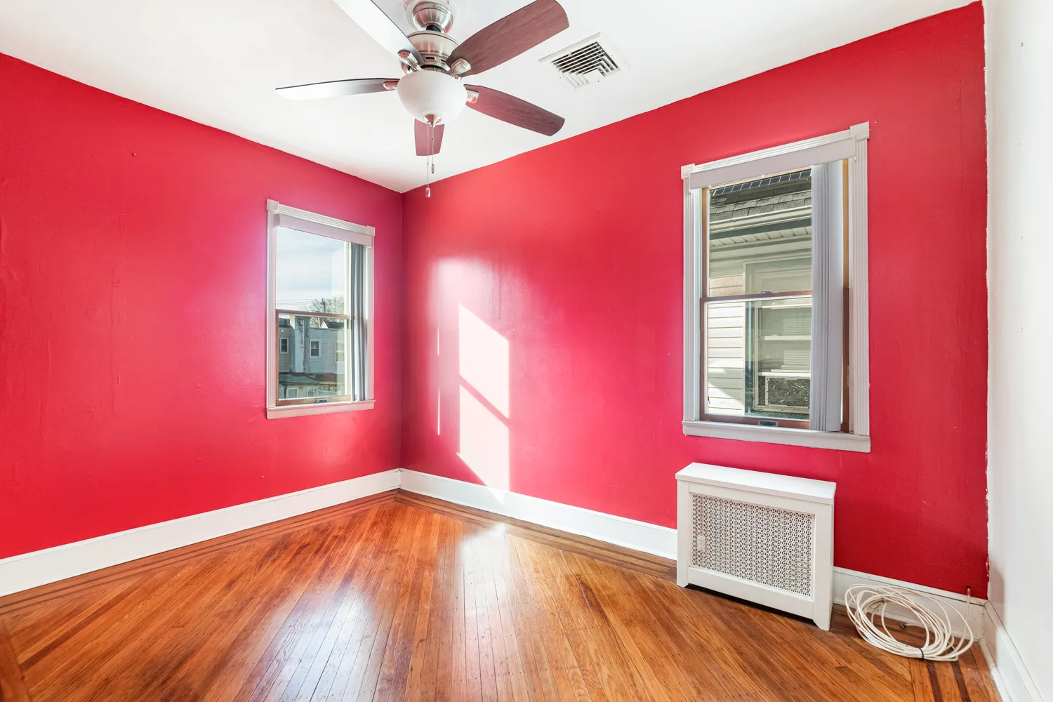 a view of a livingroom with a window and wooden floor
