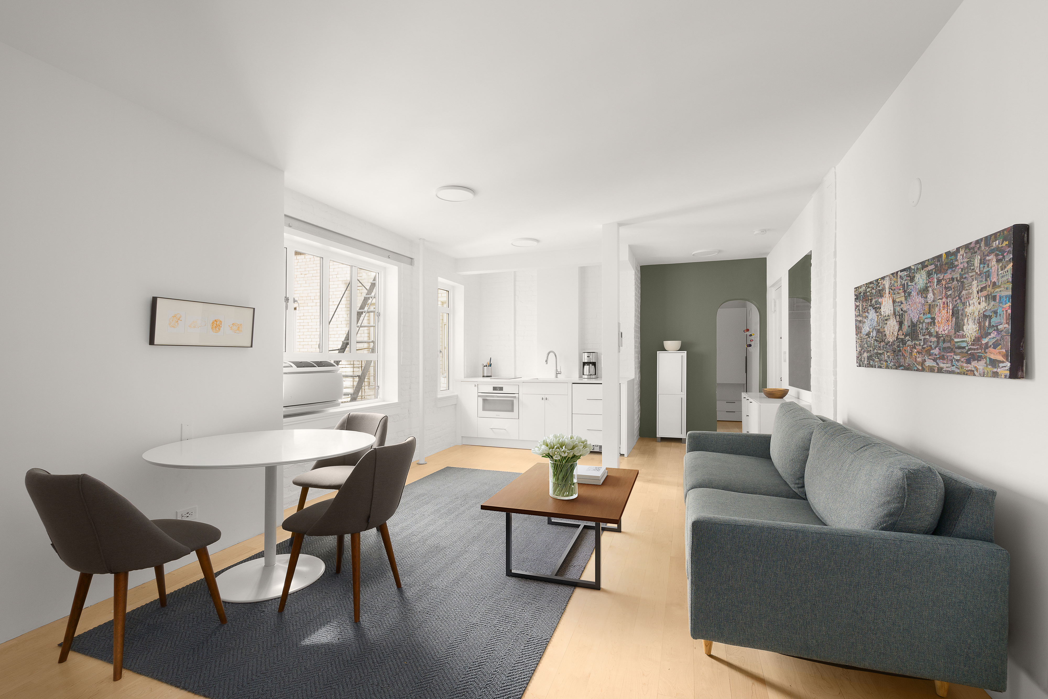 165 West 20th Street, Unit 5F Manhattan, NY 10011 - Photo 3 of 7 a living room with furniture and a potted plant