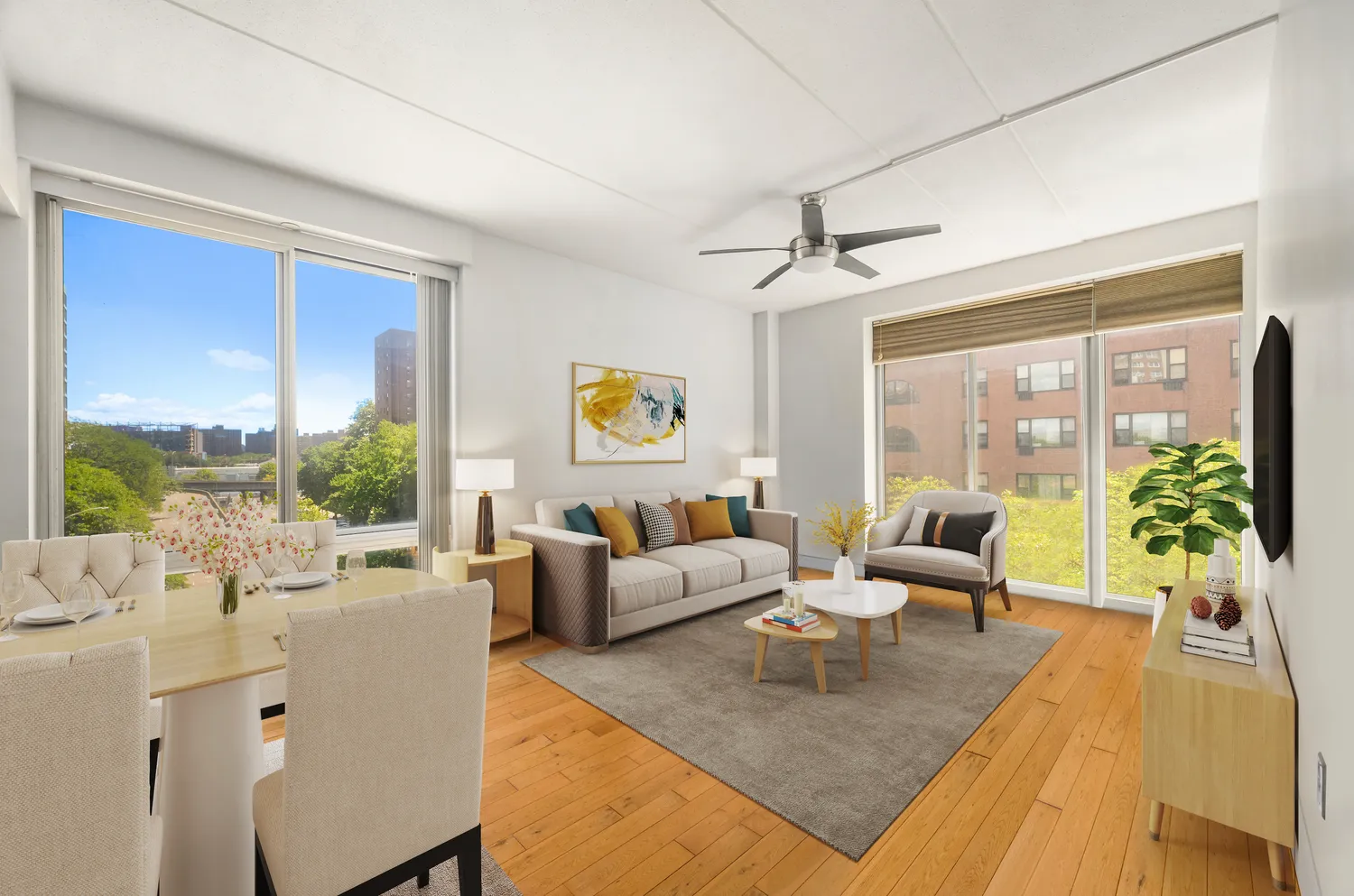 a living room with furniture large windows a rug and a chandelier
