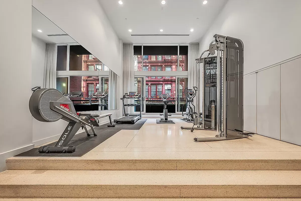a room with gym equipment and a large window