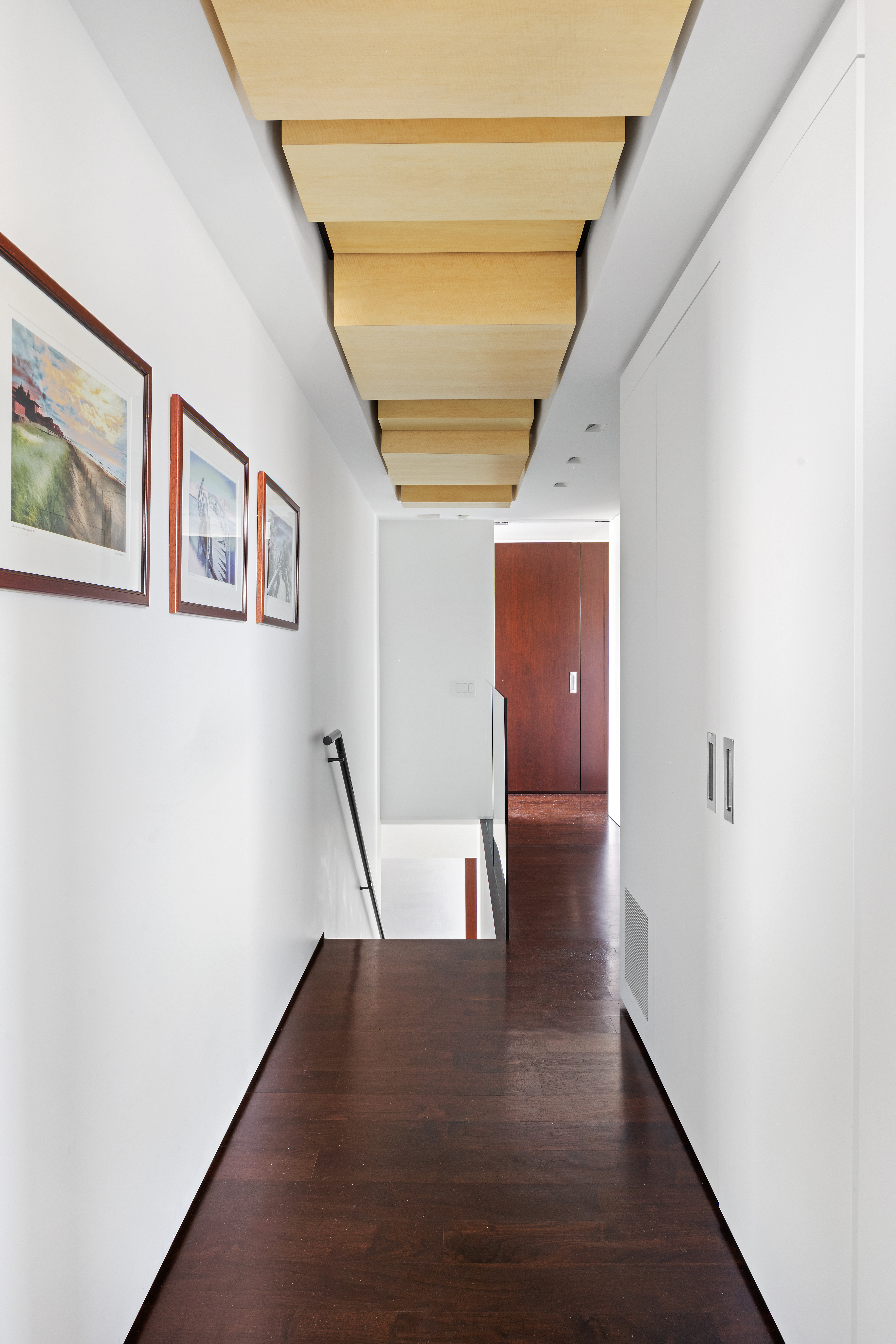 24 5th Avenue, Unit PH1701 Manhattan, NY 10011 - Photo 16 of 24 a view of hallway with stairs and wooden floor