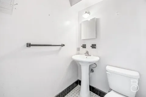 a bathroom with a sink a toilet and mirror