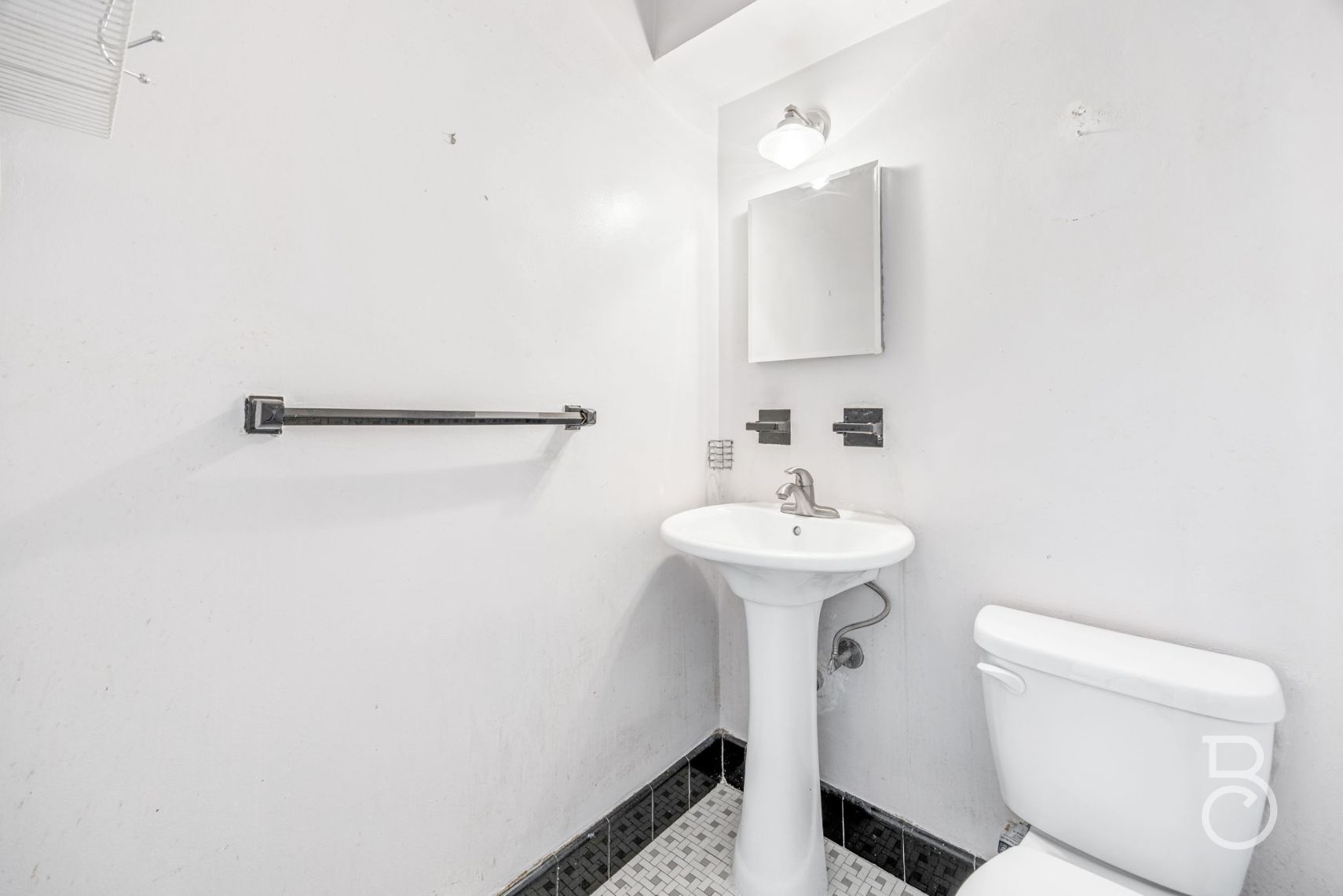 33-47 14th Street, Unit 6D Queens, NY 11106 - Photo 9 of 12 a bathroom with a sink a toilet and mirror