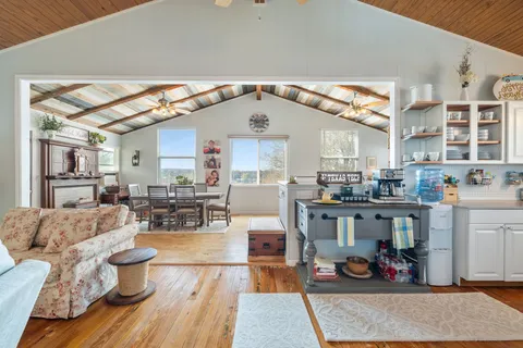 a living room with furniture and kitchen view