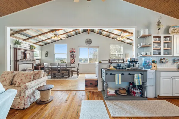 a living room with furniture and kitchen view