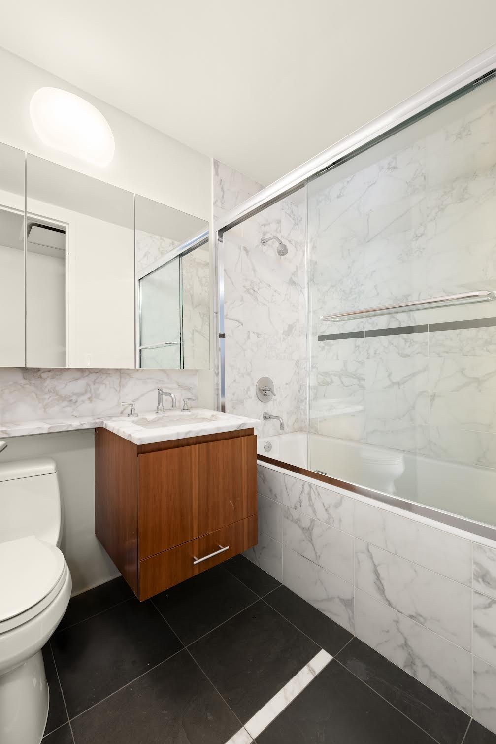 505 Greenwich Street, Unit 10G Manhattan, NY 10013 - Photo 6 of 7 a bathroom with a sink a toilet and shower
