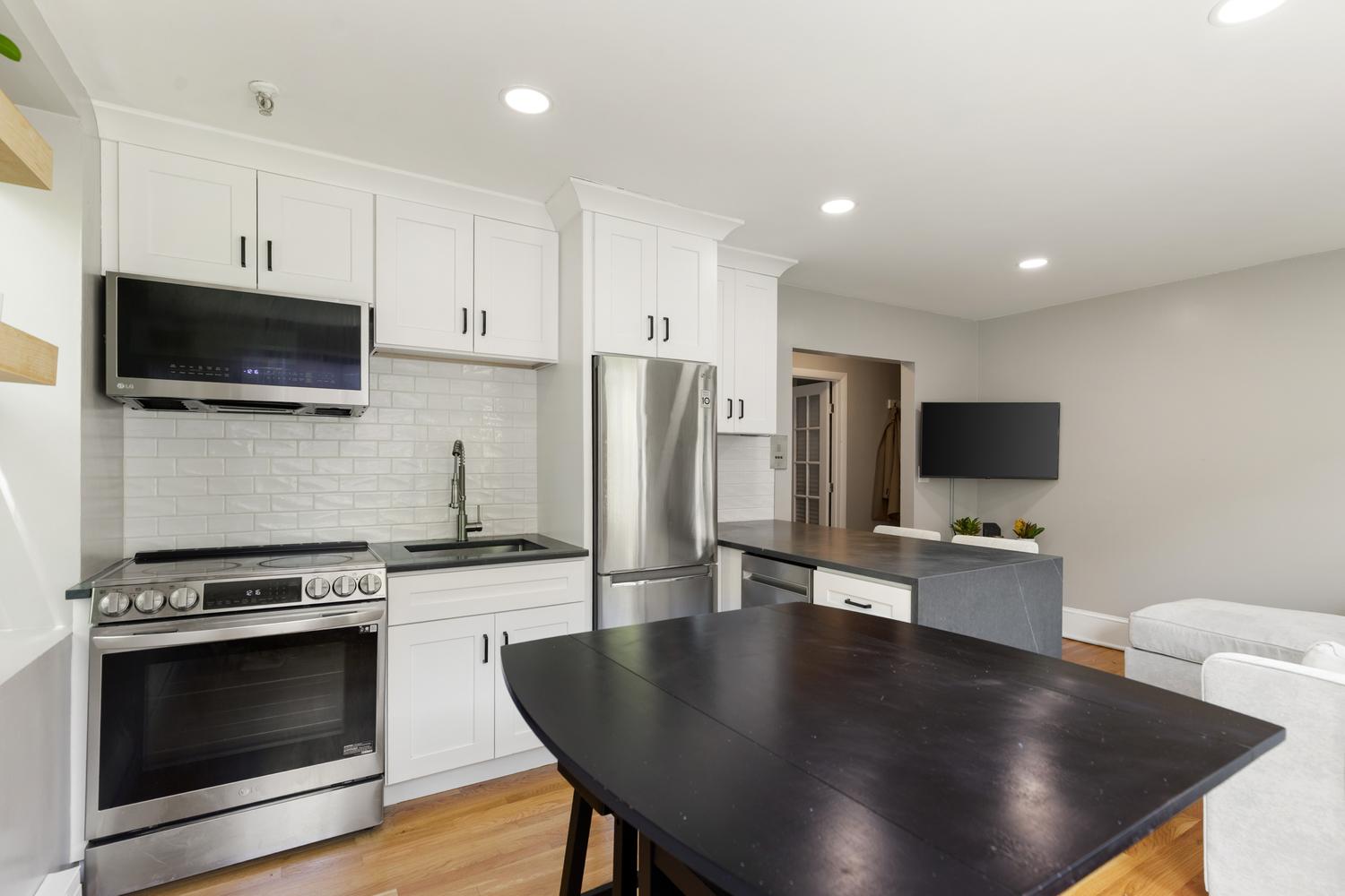 56 Prince Street Boston, MA 02113 - Photo 3 of 8 a living room with stainless steel appliances a fireplace a flat screen tv and view kitchen