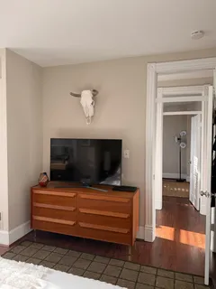 a view of room that has a couch and a flat screen tv