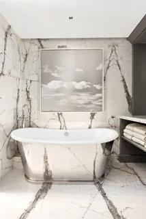 a bathroom with a bathtub and a shower