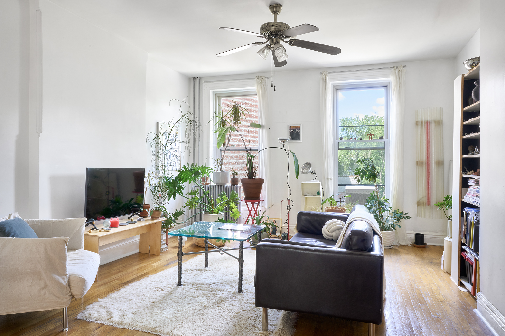276 Stuyvesant Avenue, Unit 2 Brooklyn, NY 11221 - Photo 1 of 11 a living room with furniture and a flat screen tv