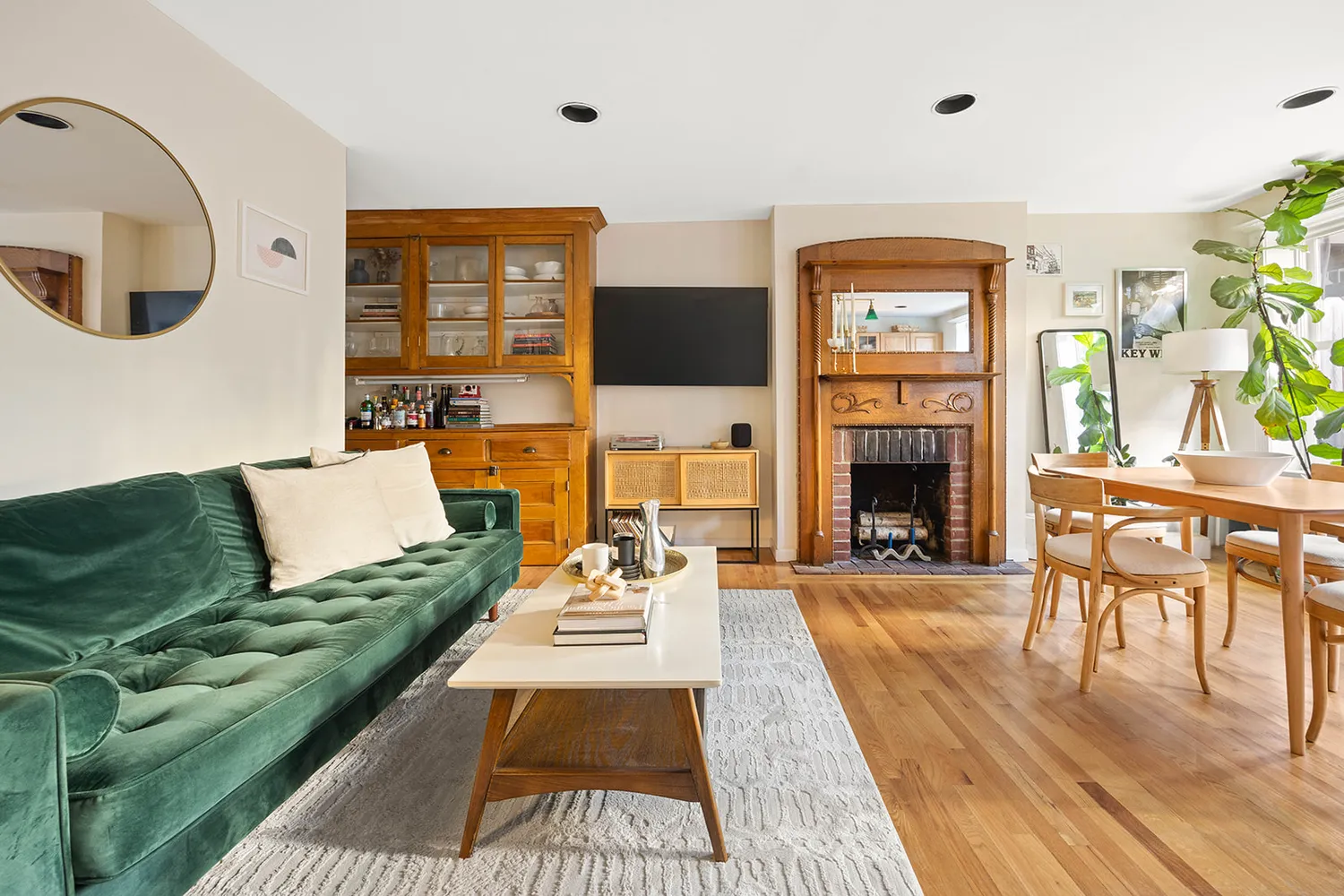 a living room with furniture a fireplace and a flat screen tv
