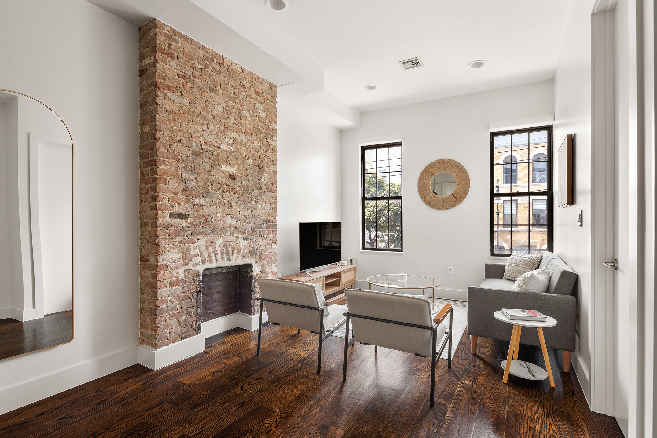 a living room with fireplace furniture and a window