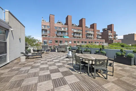 a view of a patio with table and chairs and potted plants