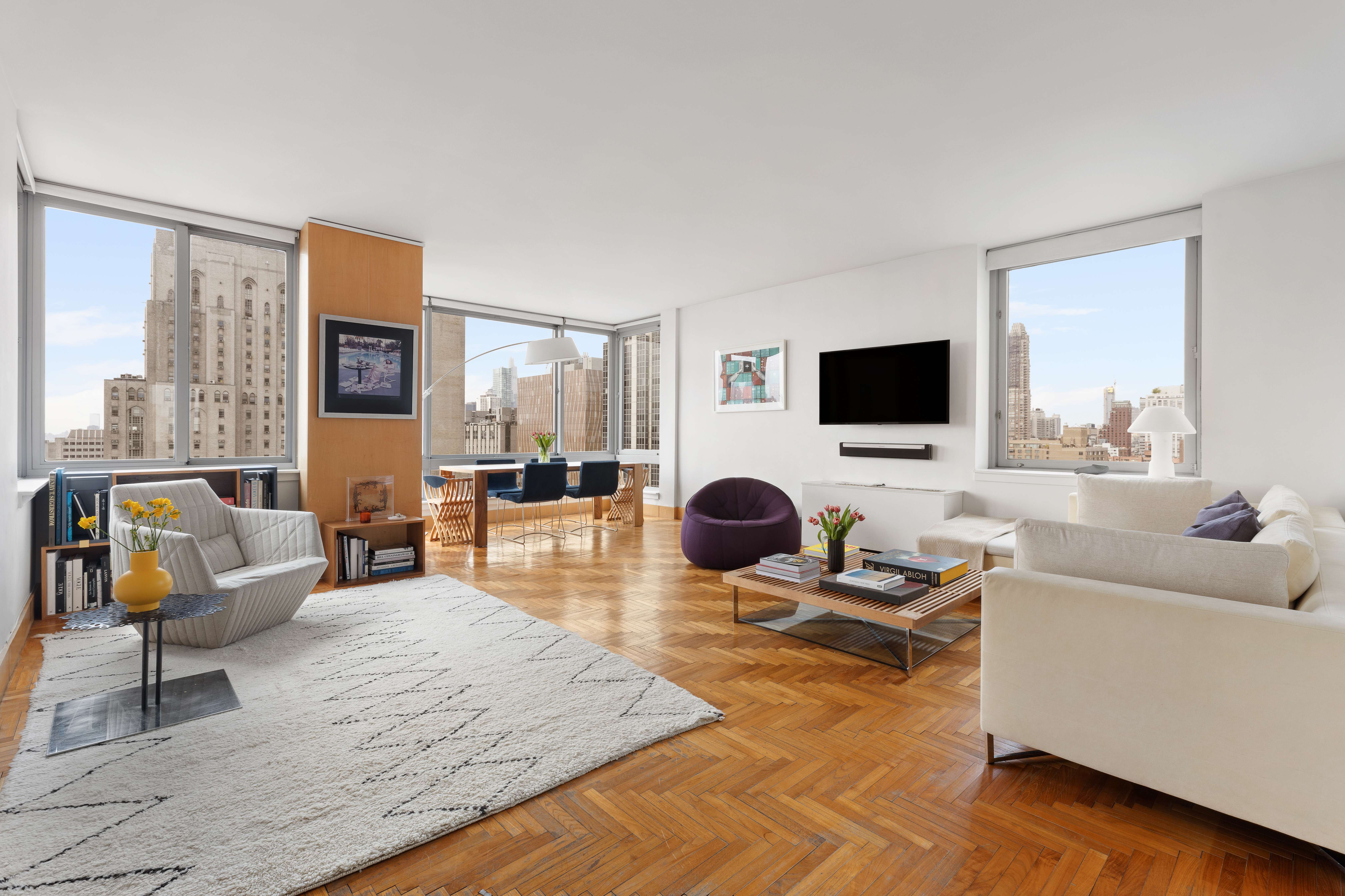 524 East 72nd Street, Unit 28DE Manhattan, NY 10021 - Photo 9 of 14 a living room with furniture and a flat screen tv