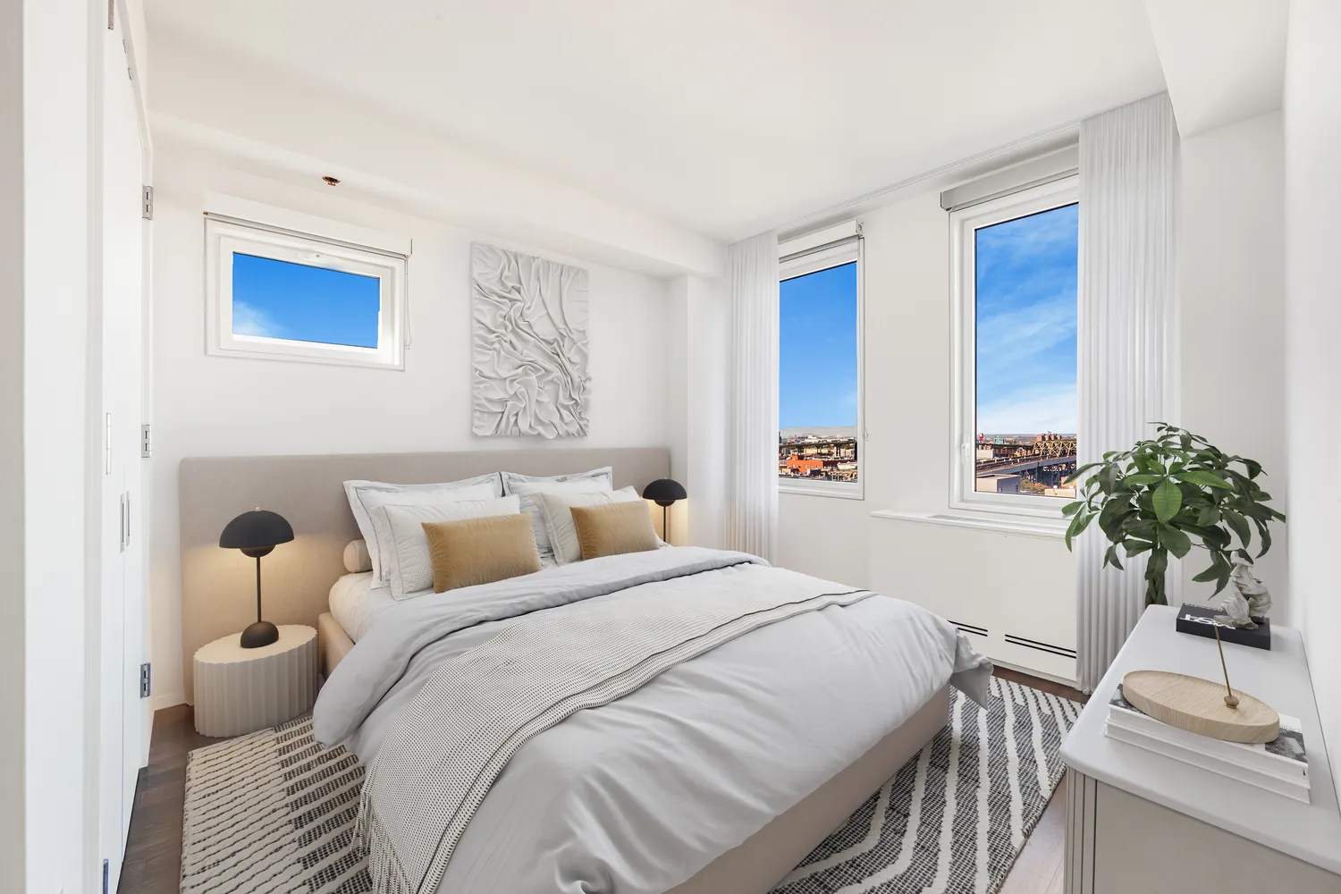 a bedroom with a bed and a potted plant