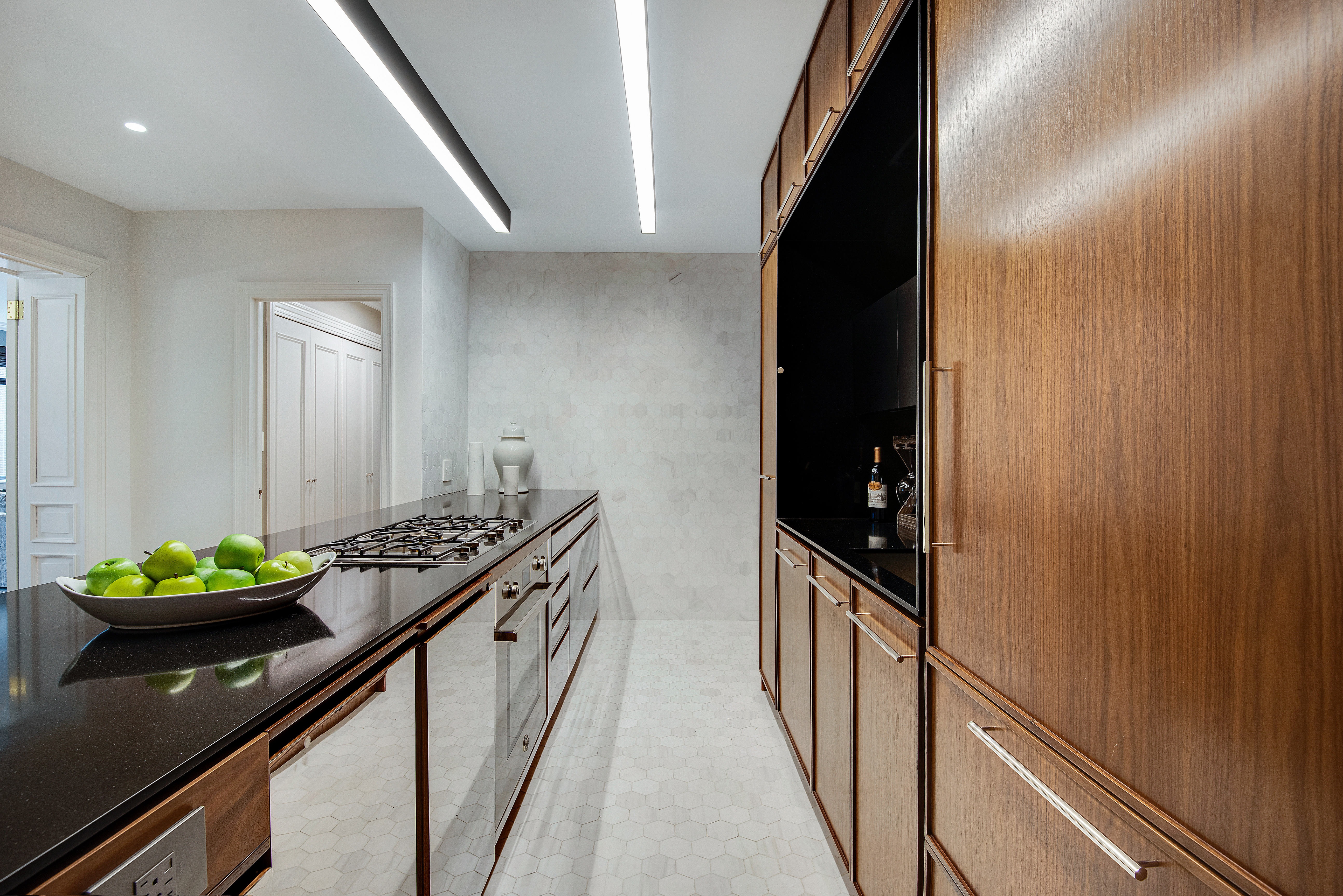 439 East 51st Street, Unit 8A Manhattan, NY 10022 - Photo 7 of 13 a kitchen with blue cabinets and a stove