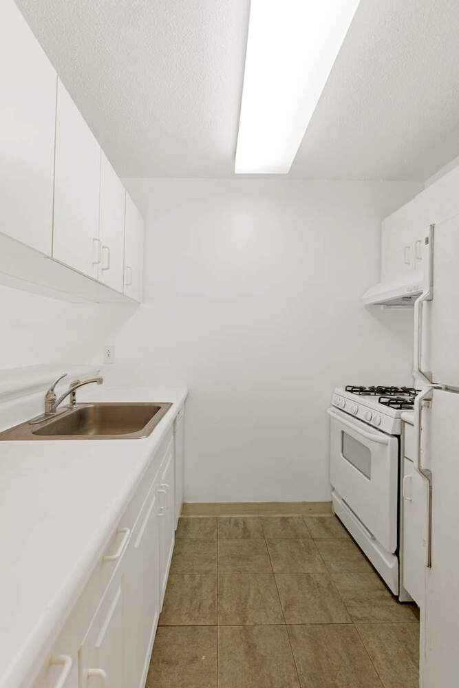 376 Broadway, Unit 6F Manhattan, NY 10013 - Photo 4 of 17 a kitchen with a sink stove and cabinets
