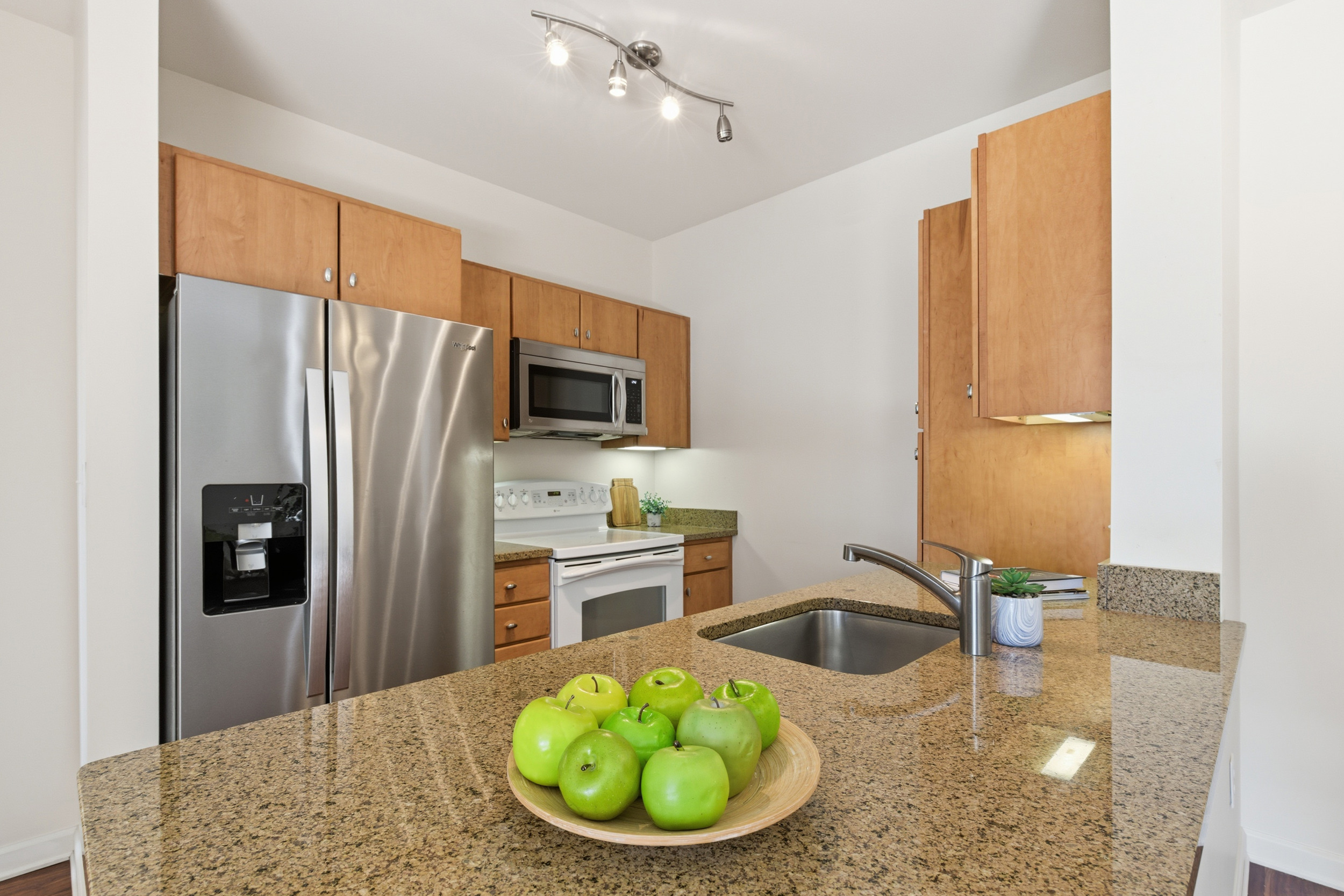 Repton Circle, Unit 3204 Watertown, MA 02472 - Photo 7 of 18 a kitchen with a sink a counter top space cabinets and stainless steel appliances