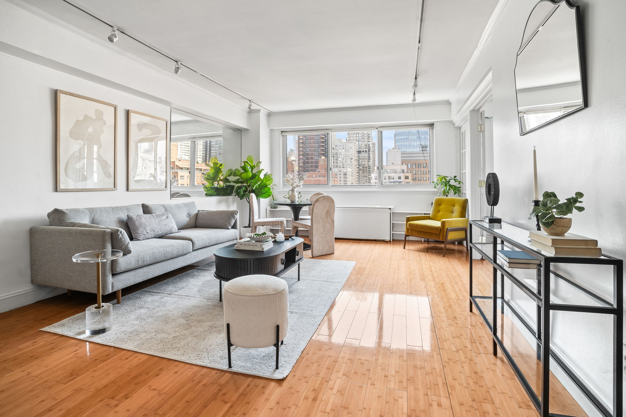 401 East 65th Street, Unit 12F Manhattan, NY 10065 - Photo 2 of 18 a living room with furniture and a large window