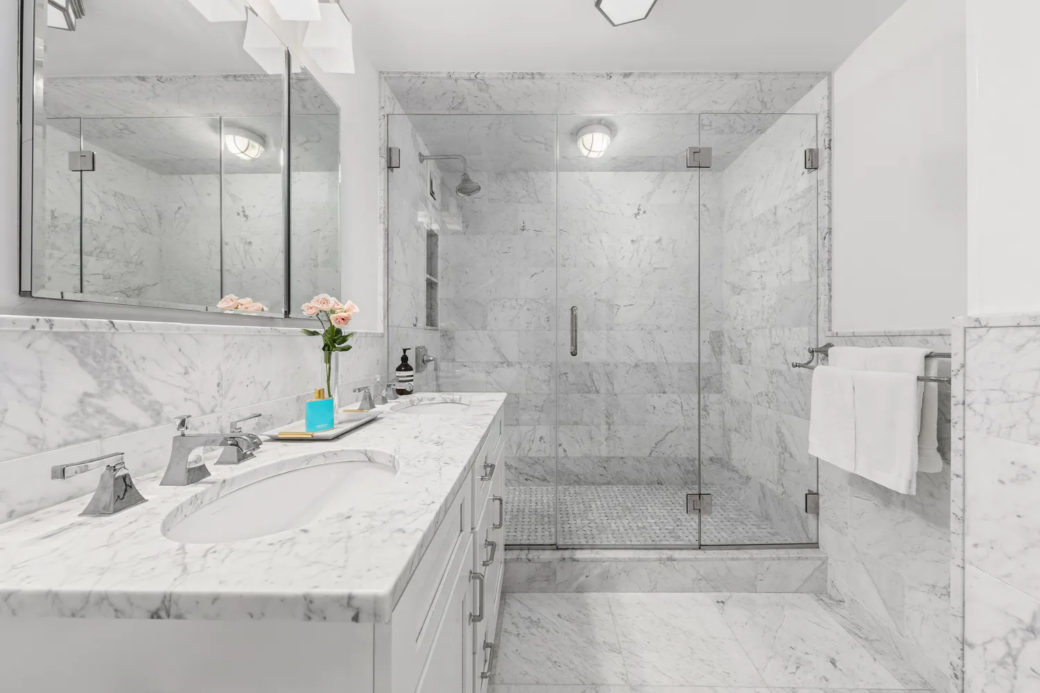 a bathroom with a granite countertop shower a sink and a mirror