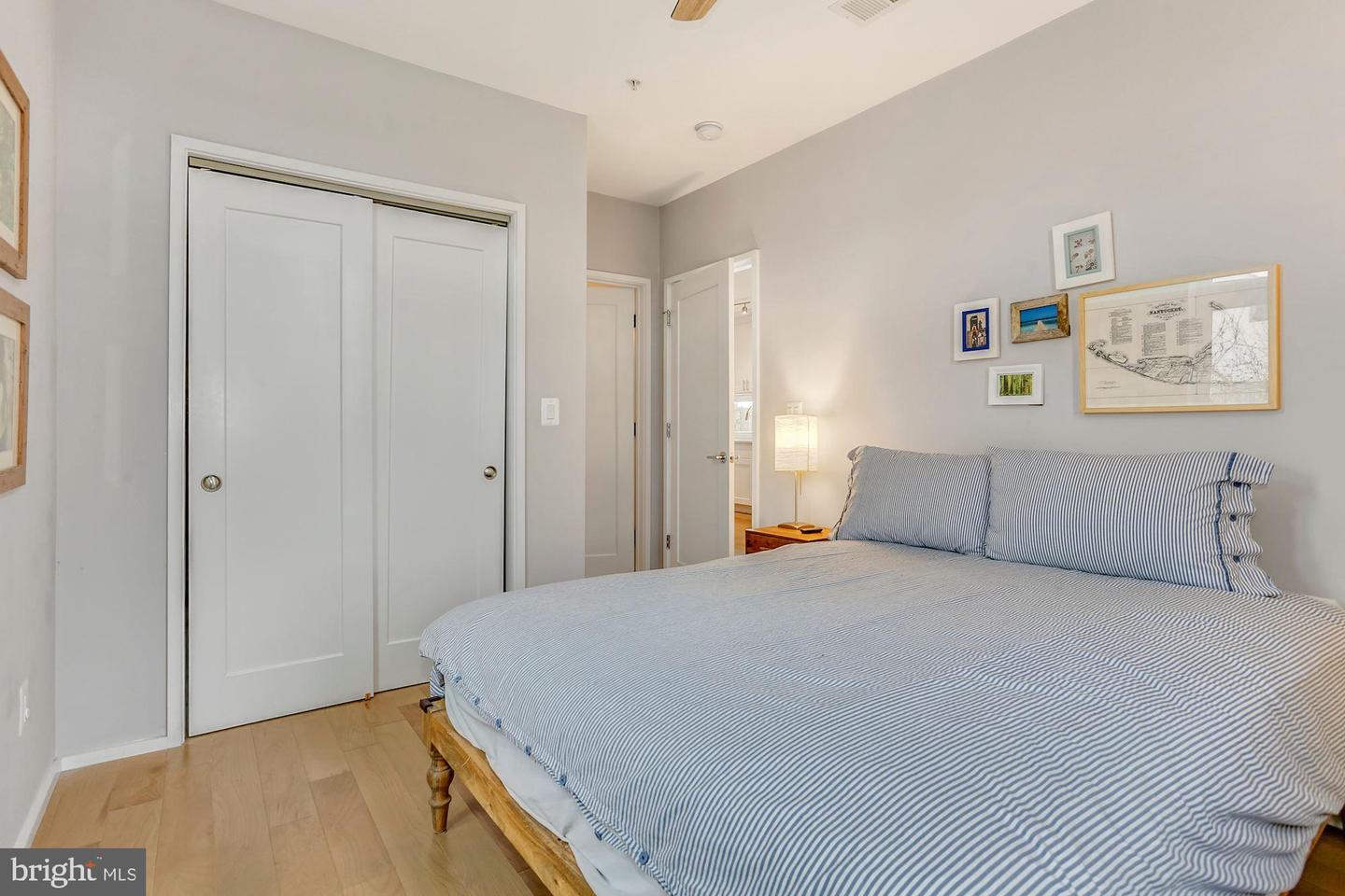 129 Varnum Street Northwest, Unit 6 Washington, DC 20011 - Photo 18 of 25 a bedroom with a bed and a painting on the wall