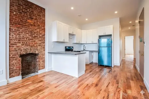 a kitchen with a refrigerator and a stove top oven