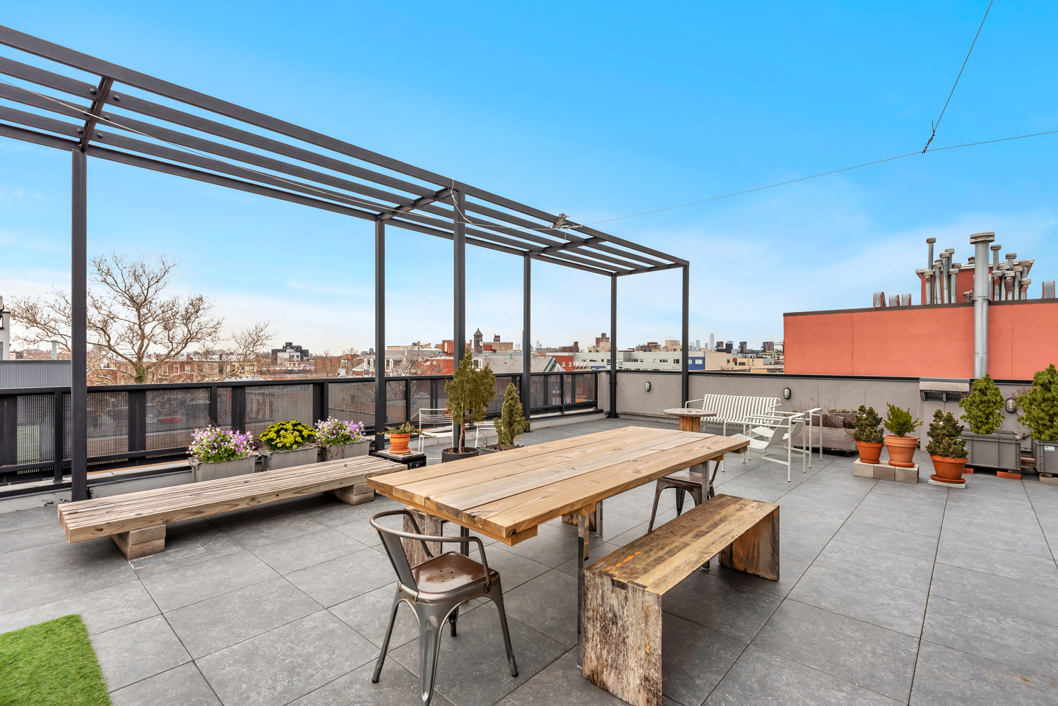 267 Evergreen Avenue, Unit PH Brooklyn, NY 11221 - Photo 15 of 19 a outdoor space with patio furniture and barbeque oven