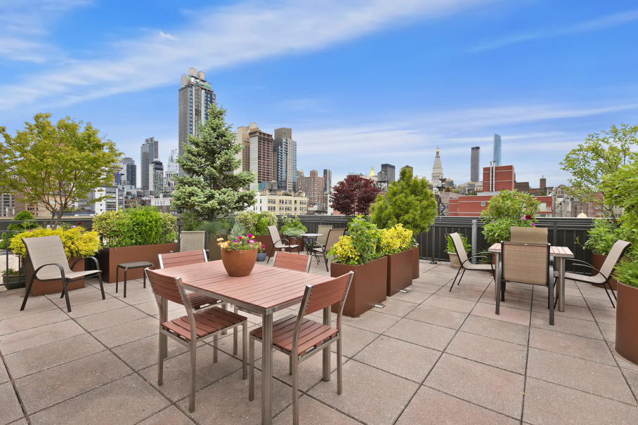 201 West 21st Street, Unit 9A Manhattan, NY 10011 - Photo 10 of 13 a view of a patio with a table and chairs and potted plants