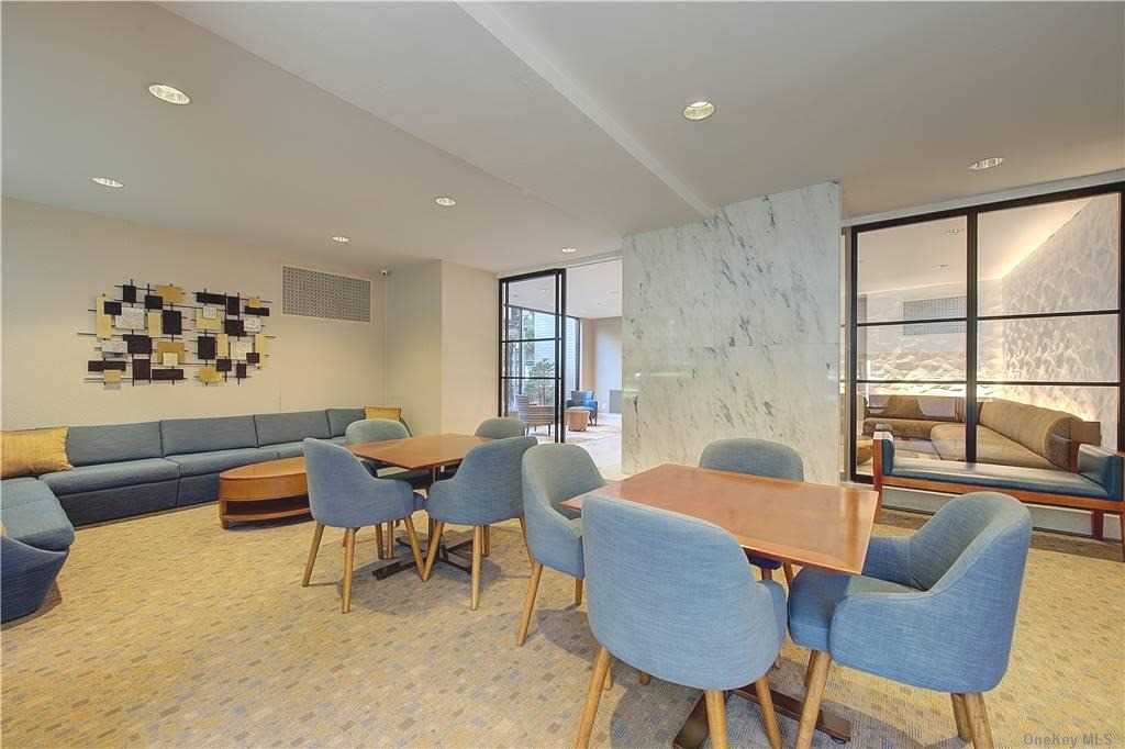 66-36 Yellowstone Boulevard, Unit 24A Queens, NY 11375 - Photo 15 of 20 a living room with furniture and a large window
