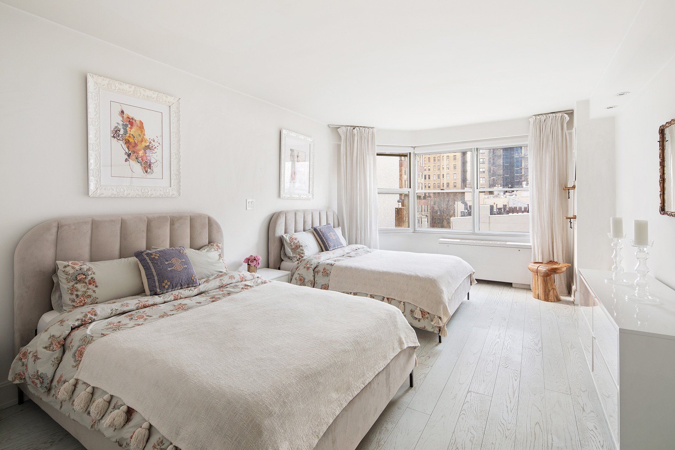 150 East 61st Street, Unit 7E Manhattan, NY 10065 - Photo 8 of 12 a bedroom with two beds and a large window