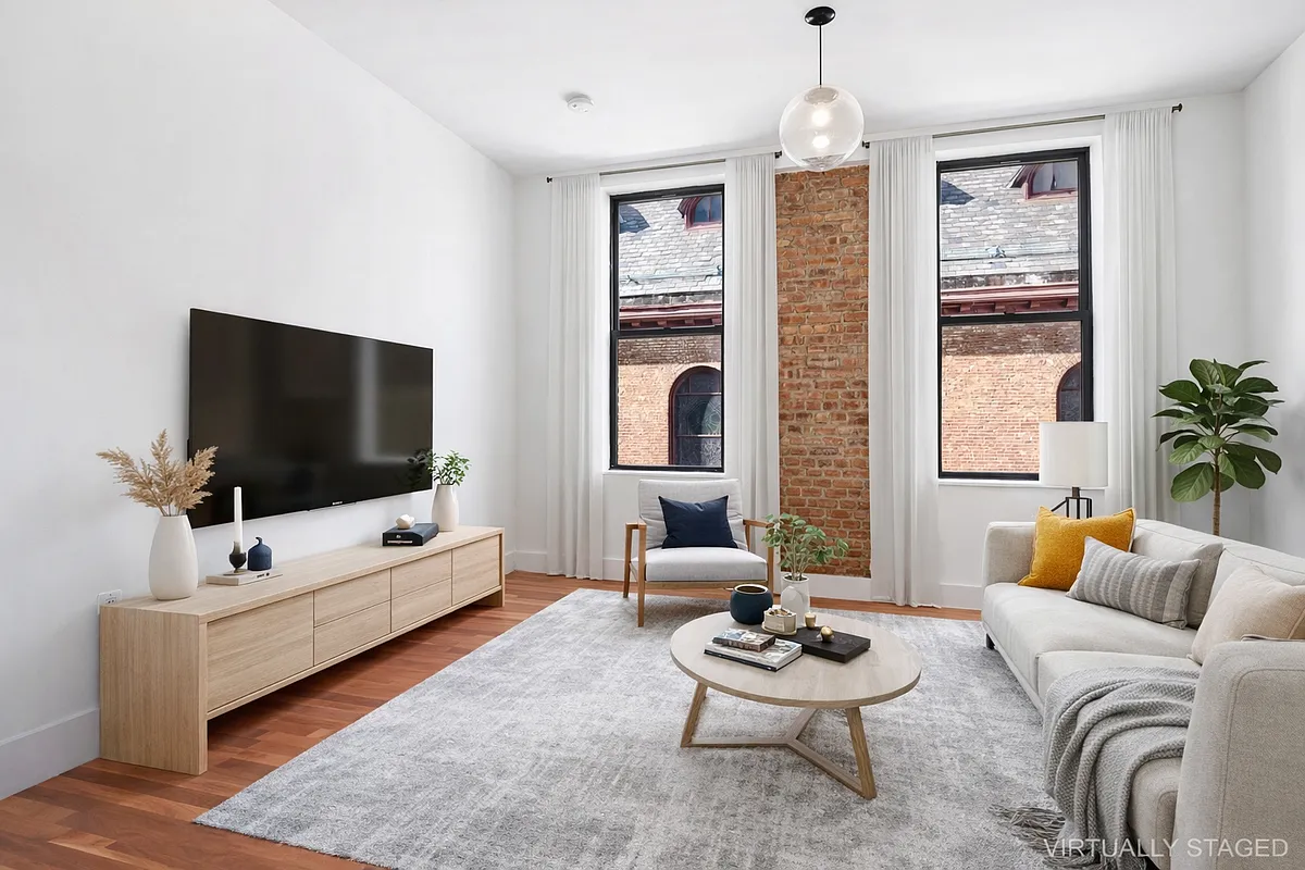 180 Bainbridge Street, Unit 211 Brooklyn, NY 11233 - Photo 2 of 21 a living room with furniture and a flat screen tv