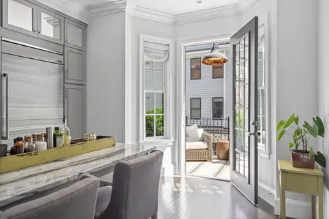 a balcony with furniture and potted plants