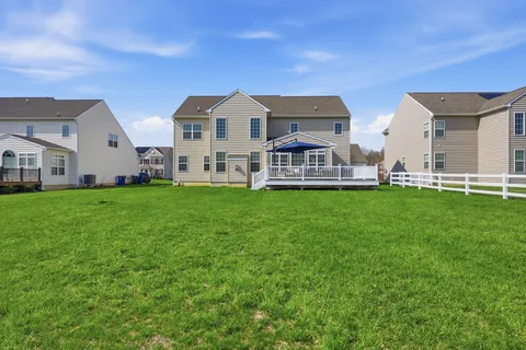 a spacious bedroom with a bed and a flat screen tv