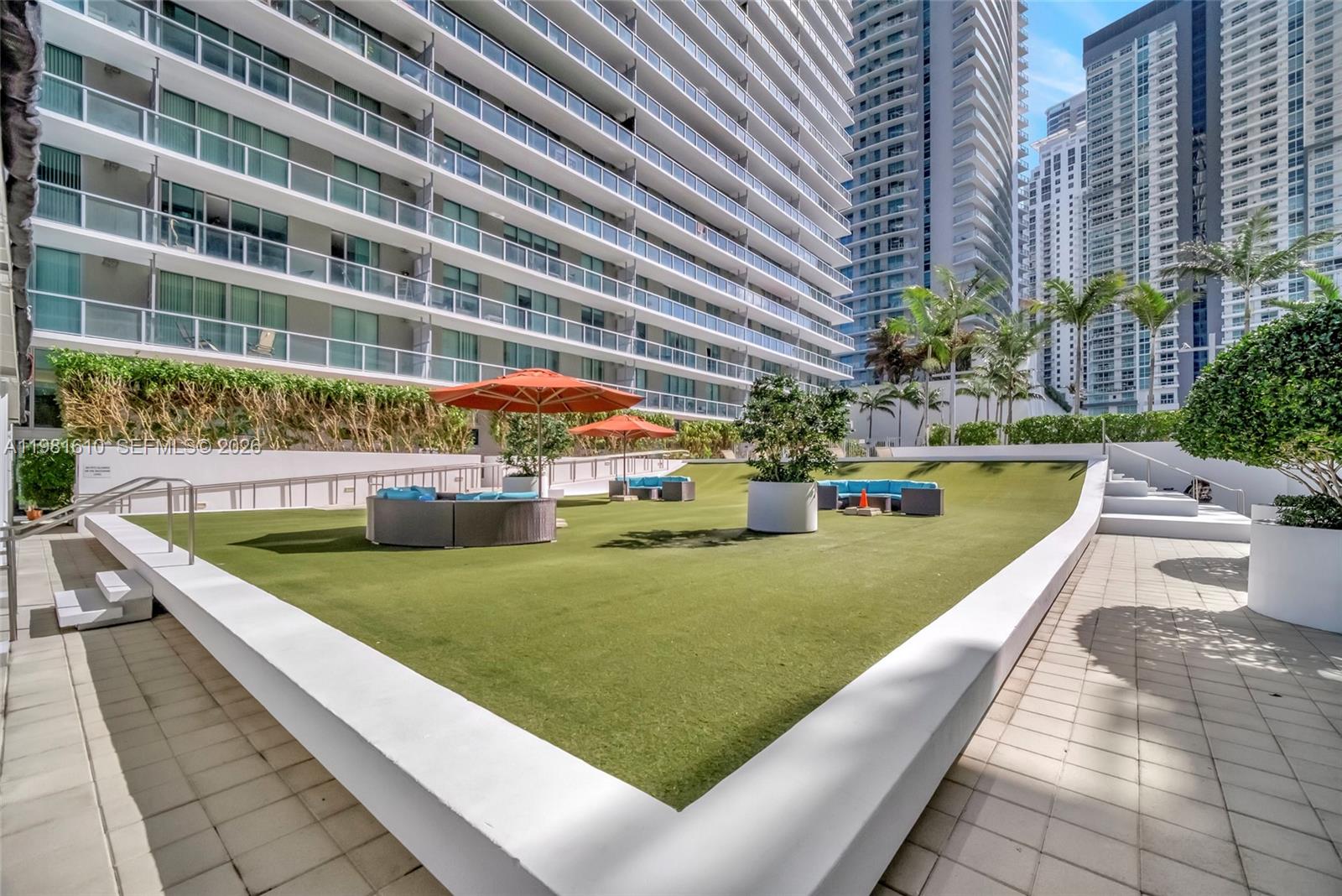 79 Southwest 12th Street, Unit 2201S Miami, FL 33130 - Photo 24 of 33 a view of a swimming pool and a yard