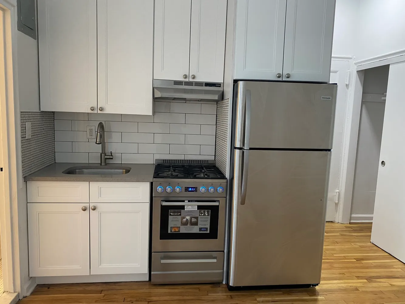 a kitchen with a refrigerator and a stove