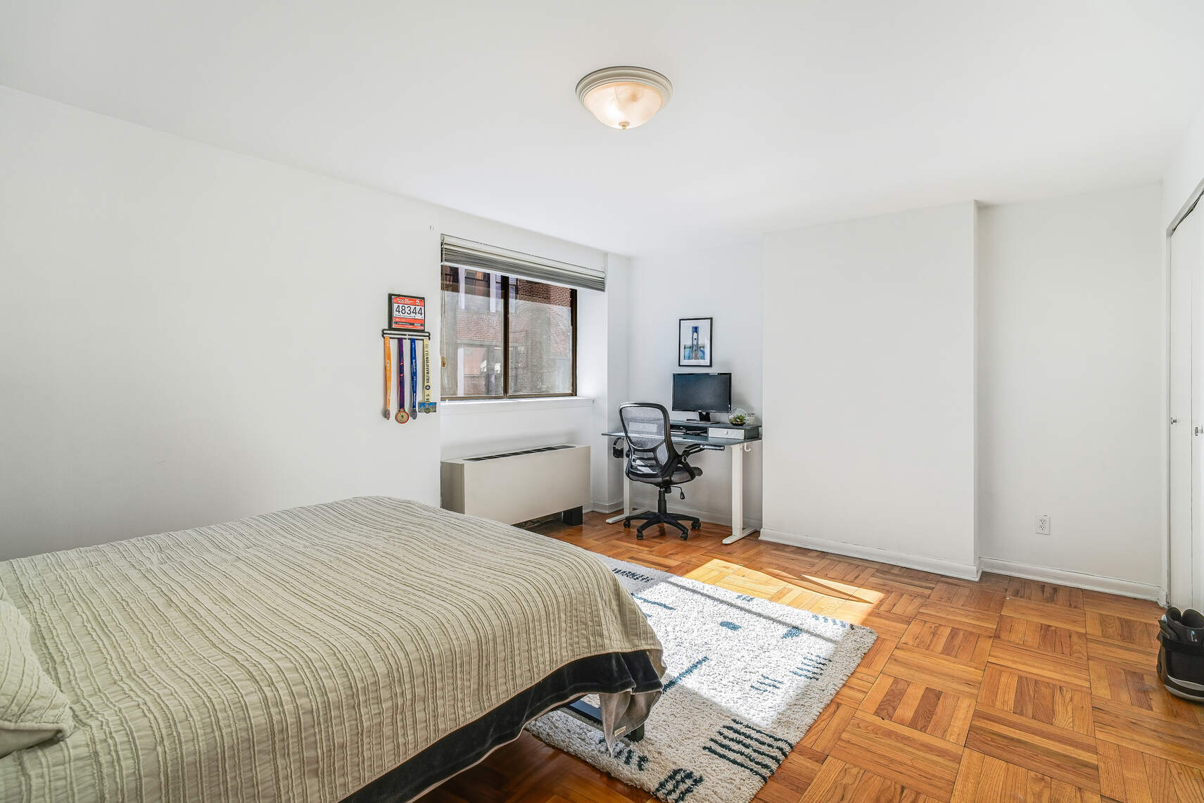 170 East 88th Street, Unit 6D Manhattan, NY 10128 - Photo 10 of 16 a bedroom with a bed and a table in it