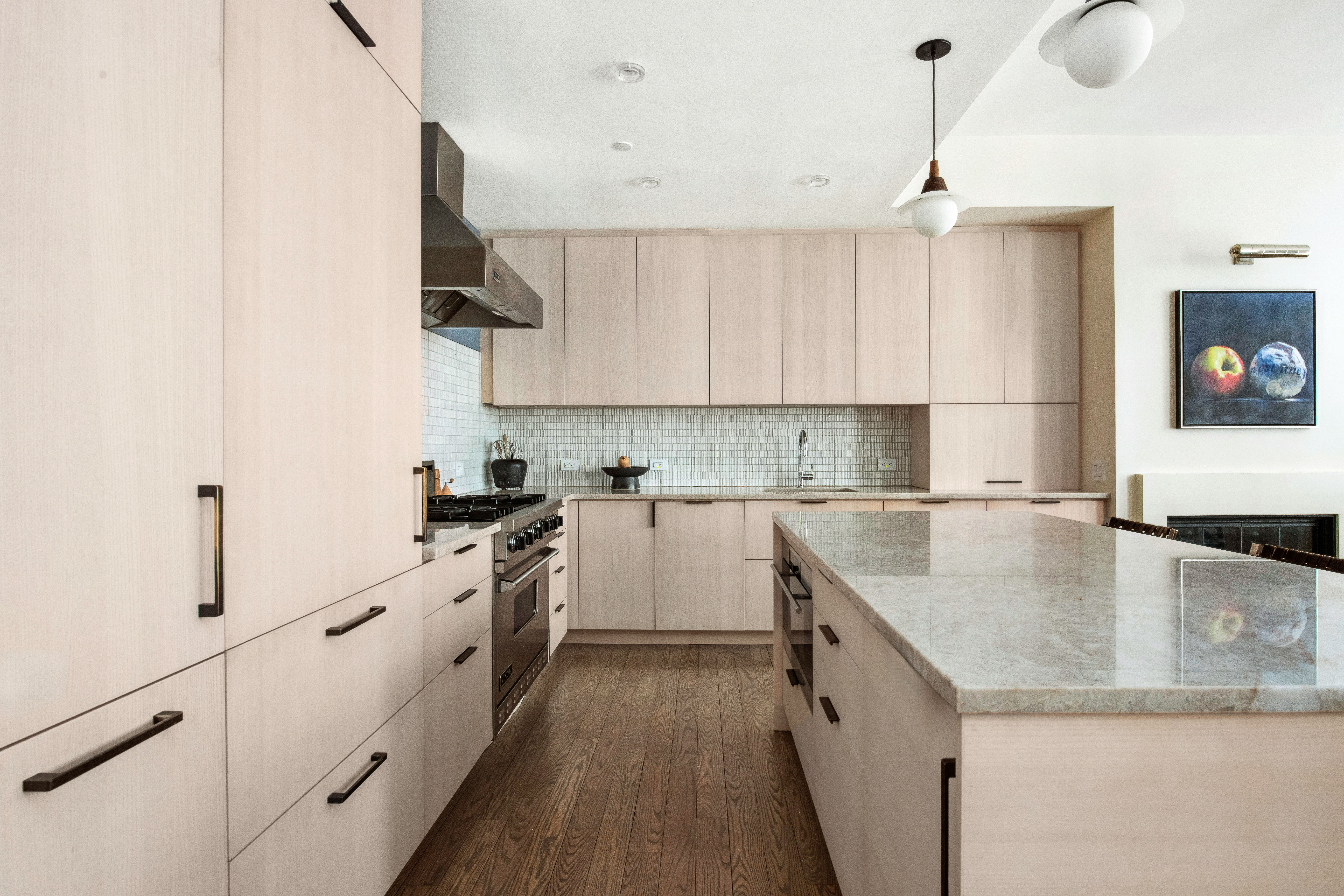 150 Nassau Street, Unit 10A Manhattan, NY 10038 - Photo 3 of 20 a kitchen with granite countertop a sink a stove and cabinets