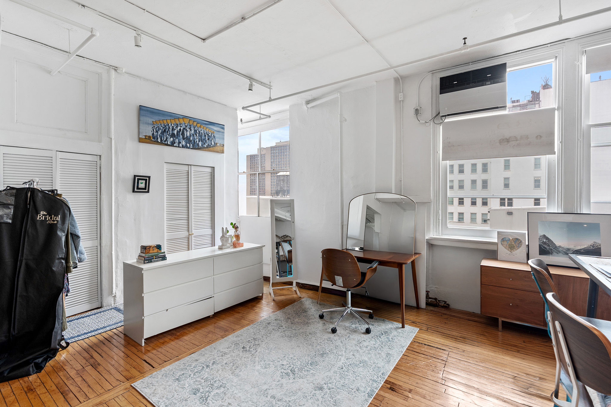 565 Broadway, Unit 8W Manhattan, NY 10012 - Photo 18 of 23 a living room with furniture and a window