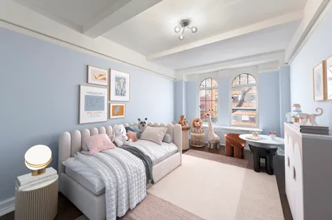 a view of a hallway with wooden floor and a chandelier