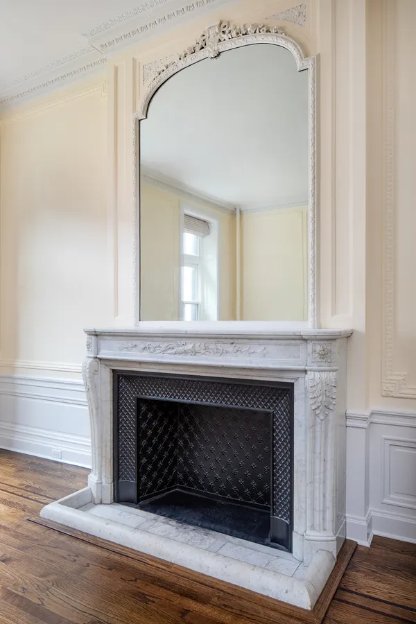a living room with a fireplace and a wooden floor