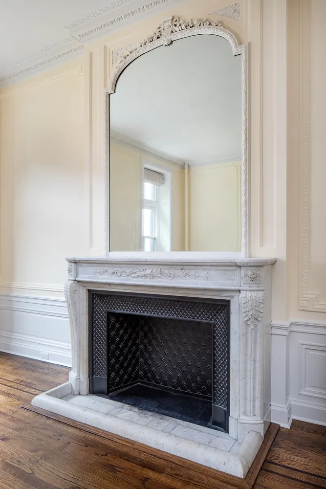 a living room with a fireplace and a wooden floor