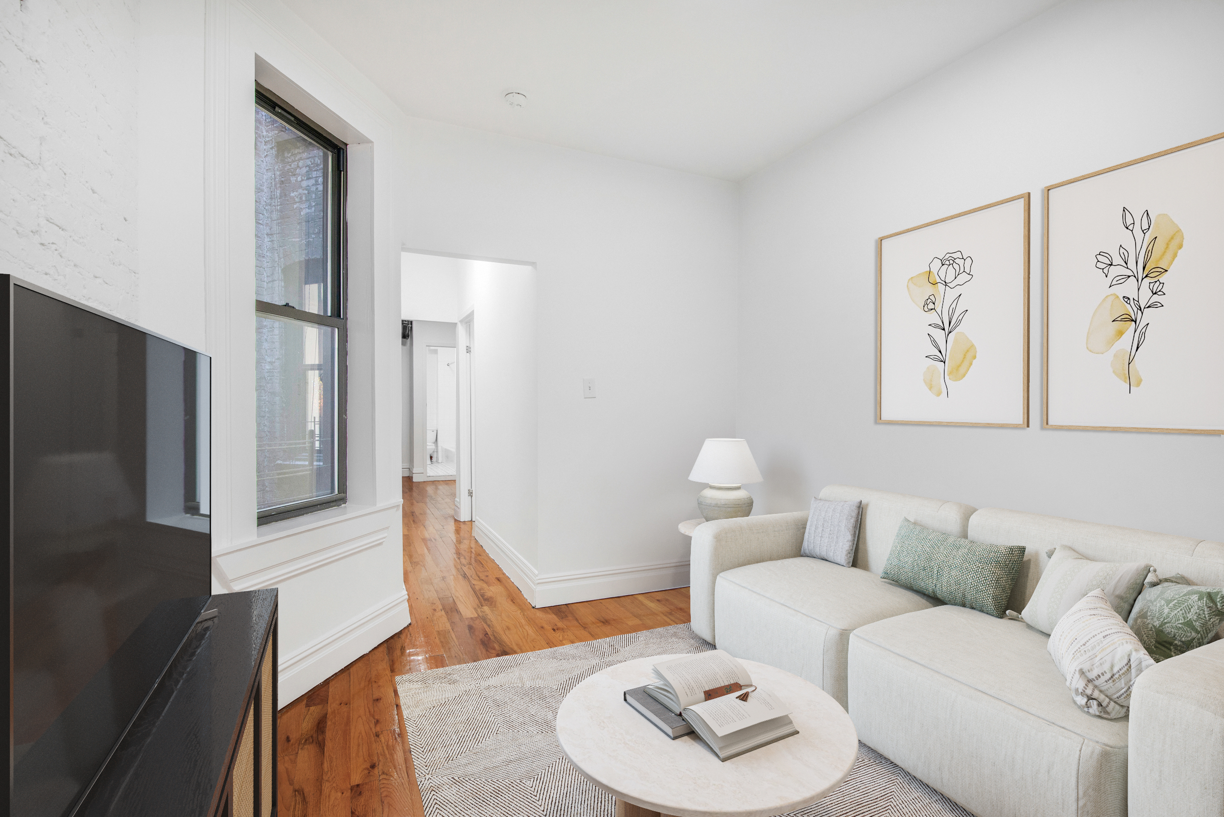 a living room with furniture and a wooden floor