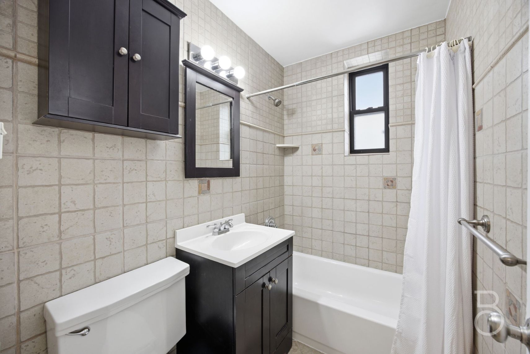 78-15 19th Drive, Unit B2 Queens, NY 11370 - Photo 9 of 17 a bathroom with a sink a toilet and shower
