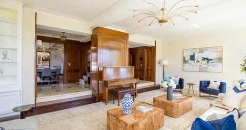 a living room with furniture and a chandelier