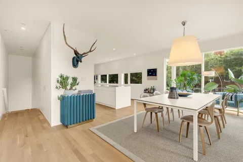 a view of a dining room with furniture window and wooden floor