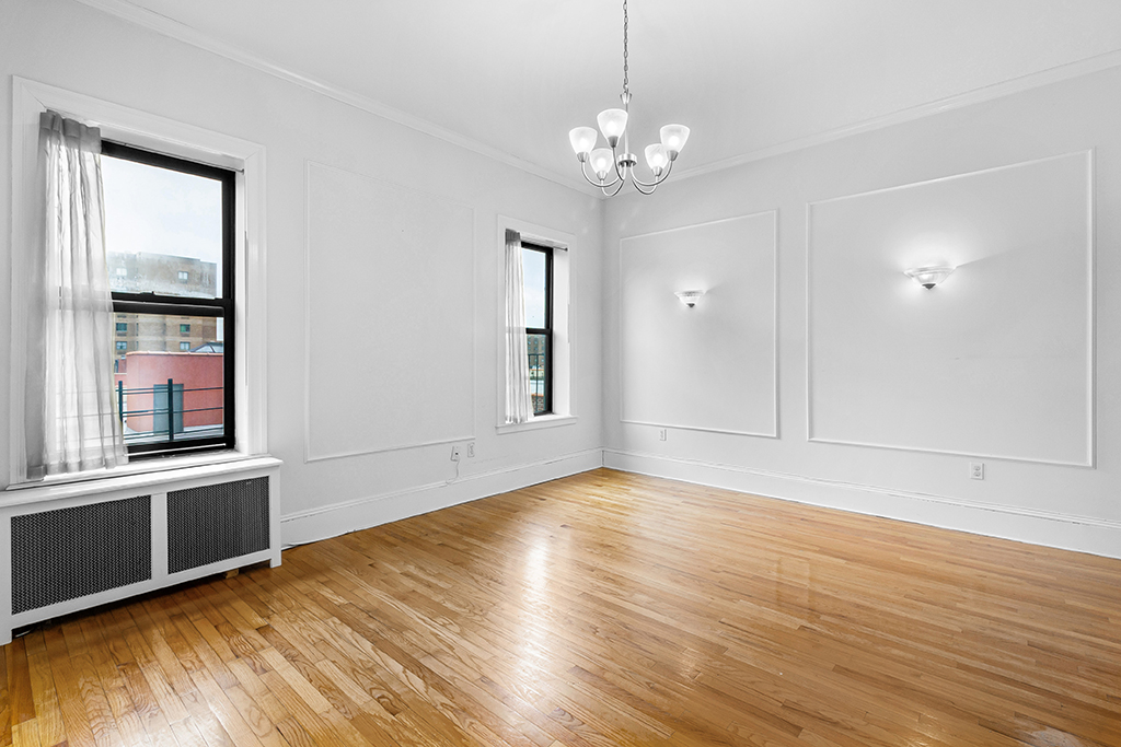 1240 Park Avenue, Unit 3B Manhattan, NY 10128 - Photo 4 of 12 a view of an empty room with wooden floor and a window