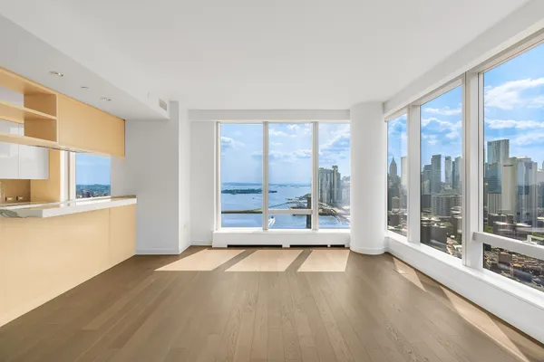 a view of a kitchen with wooden floor and a kitchen