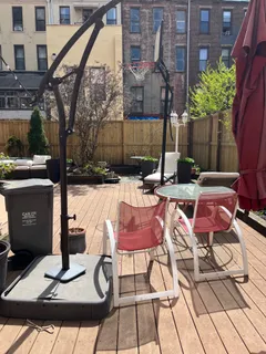 a backyard of a house with barbeque oven table and chairs