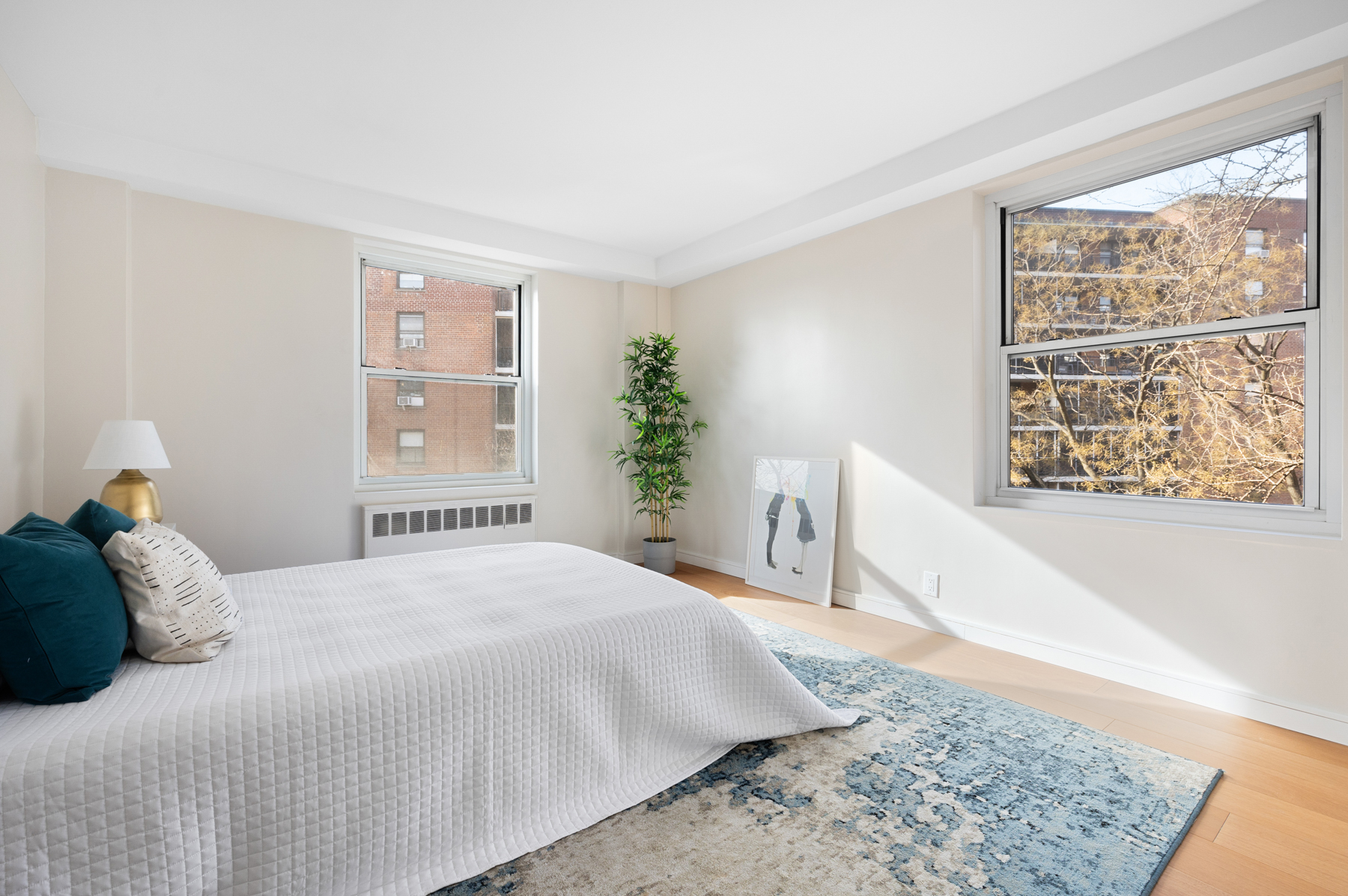 35-51 85th Street, Unit 5E Queens, NY 11372 - Photo 11 of 16 a bedroom with a large bed and a window