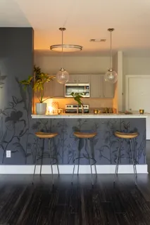 a kitchen with a sink and chairs